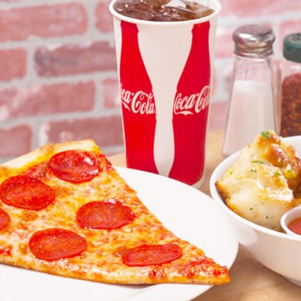 A slice of pepperoni pizza, a Coca-Cola, and garlic knots with dipping sauce.