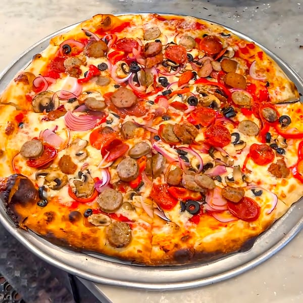 Joe's pizza with pepperoni, sausage, mushrooms, red onions, black olives, and bell peppers.
